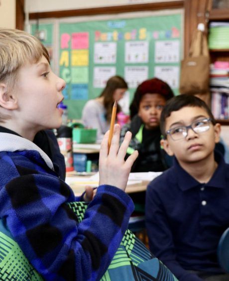 Children in classroom discussing justice